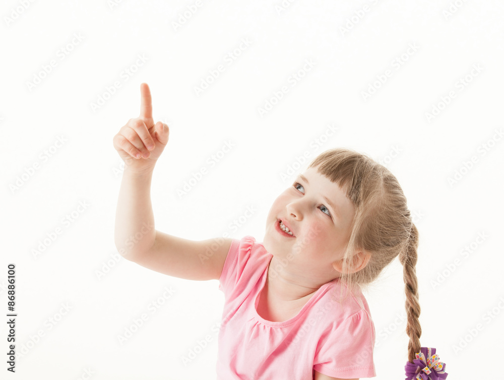 Smiling little girl indicating something up Smiling little girl indicating something up