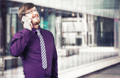 Portrait of a young businessman talking on the phone