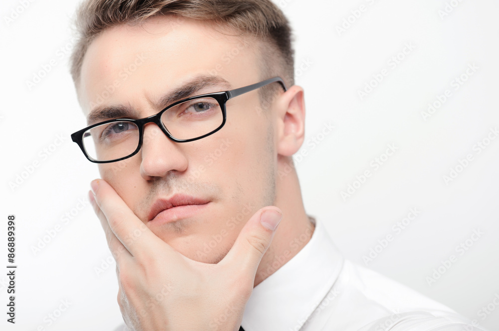 Close-up of man in glasses touching his face