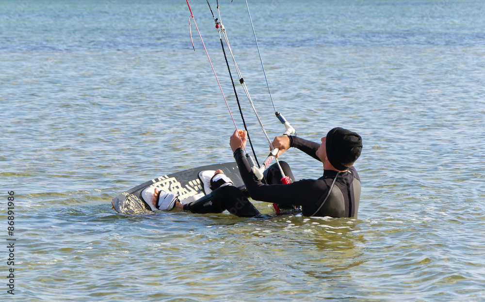 Kite Surfer gets up on the board Kite Surfer gets up on the board