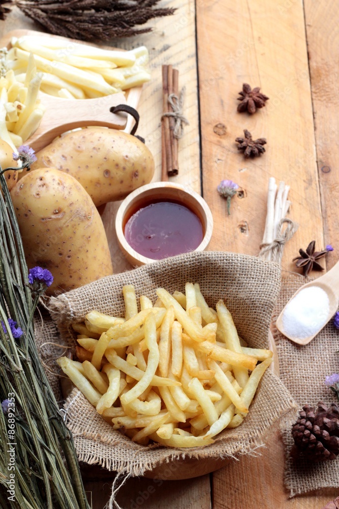 French fries and fresh sliced potatoes with ketchup. French fries and fresh sliced potatoes with ketchup.