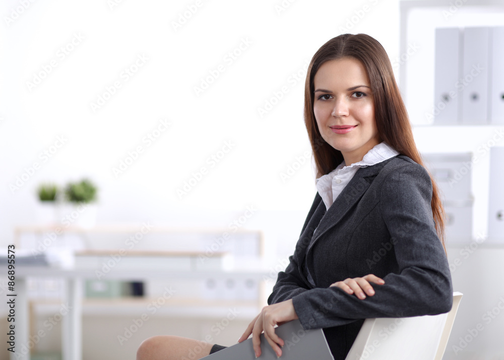 Attractive businesswoman sitting in the office Attractive businesswoman sitting in the office