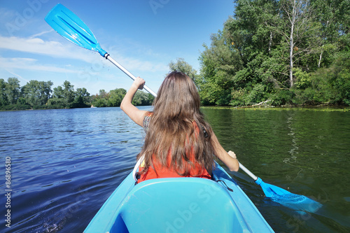 Kayaking. The woman floating on the river kayak photo