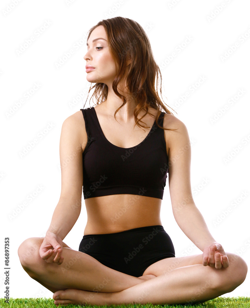 Young woman practicing yoga in the lotus position Young woman practicing yoga in the lotus position