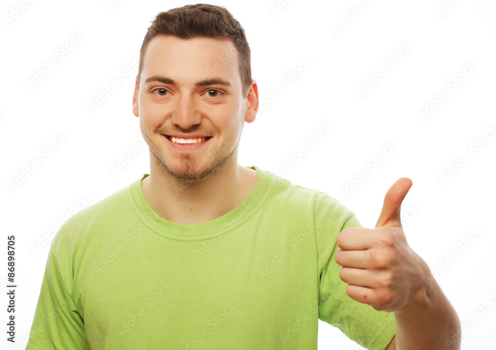 young man in green shirt  showing thumbs up. 
