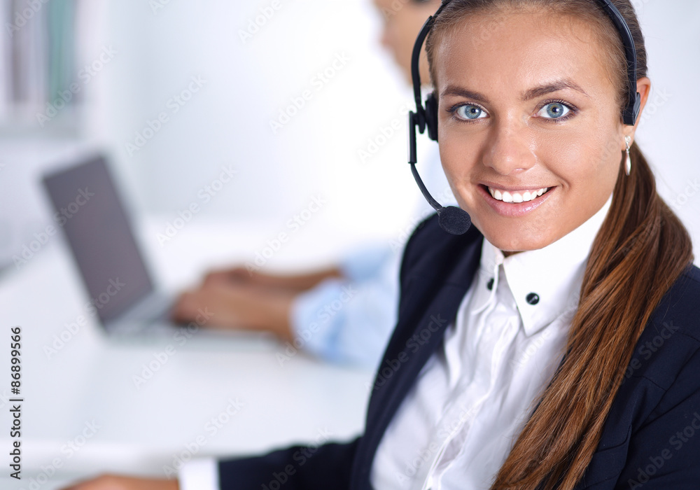 Happy female wearing headset and sitting on the desk Happy female wearing headset and sitting on the desk