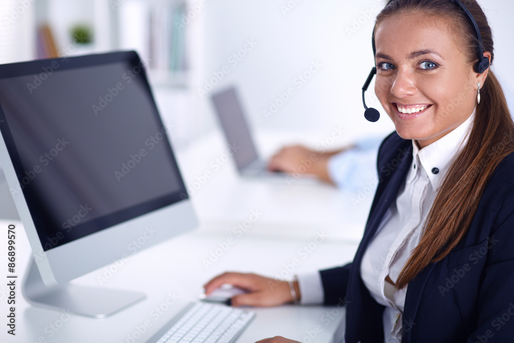 Happy female wearing headset and sitting on the desk Happy female wearing headset and sitting on the desk
