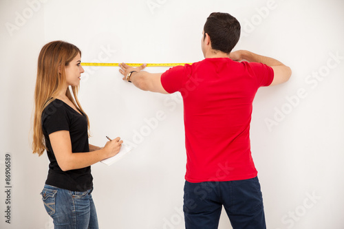 Couple taking some measurements