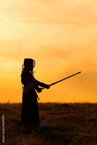 Silhouette of kendo fighter with shinai