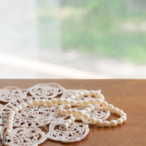 Pearl necklace on a lacy napkin