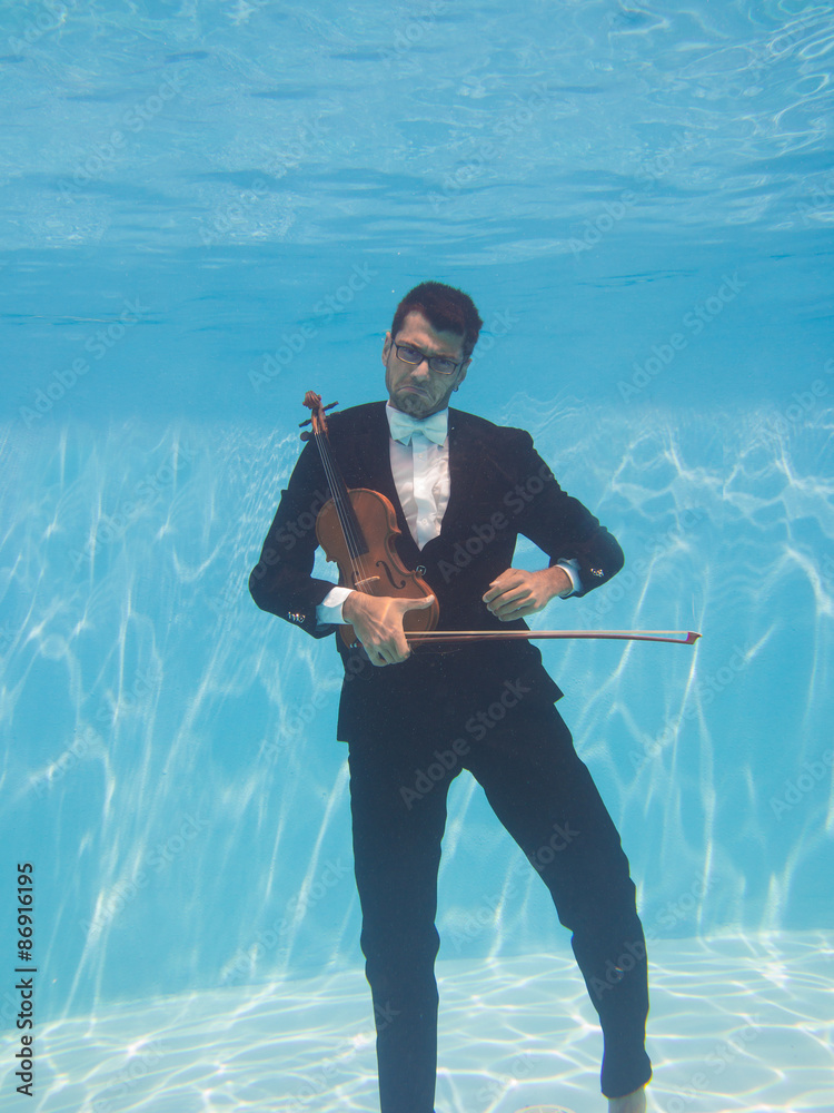 Aquatic music underwater violinist in suit