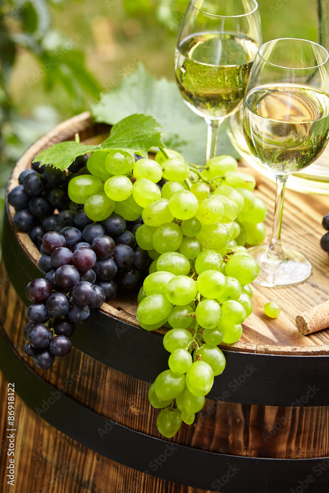 wine on wooden barrel on green garden terrace