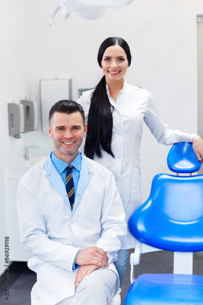 Fototapeta premium Dentist Team at Dental Clinic. Two Smiling Doctors at their Work