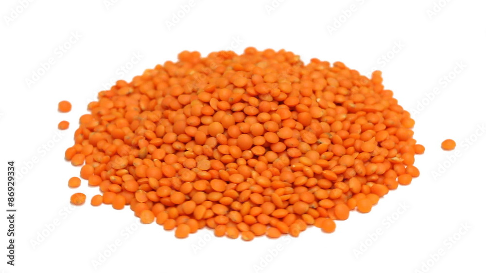 Heap of raw, uncooked red lentils rotating on white background - loopable Heap of raw, uncooked red lentils rotating on white background - loopable