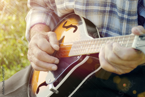 Senior man playing mandolin