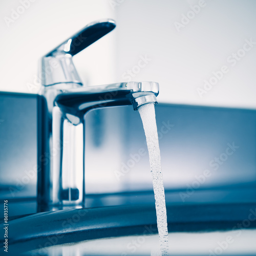 faucet with flowing water  blue tone