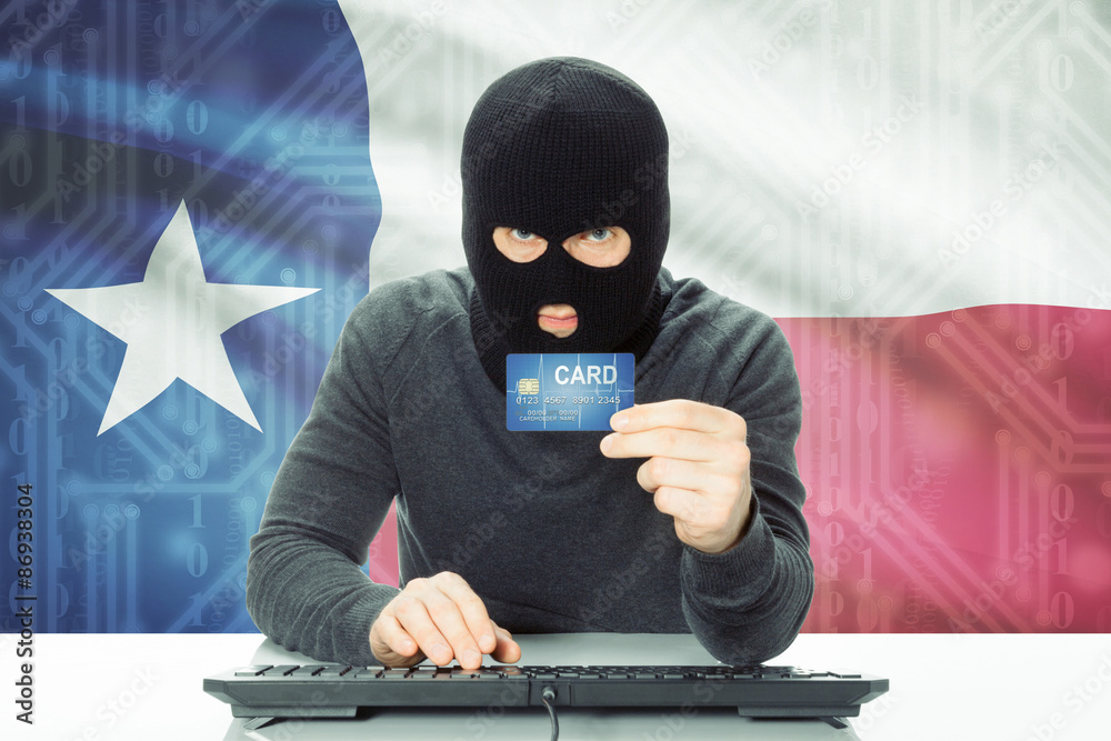 Hacker holding credit card and USA state flag on background - Texas Hacker holding credit card and USA state flag on background - Texas