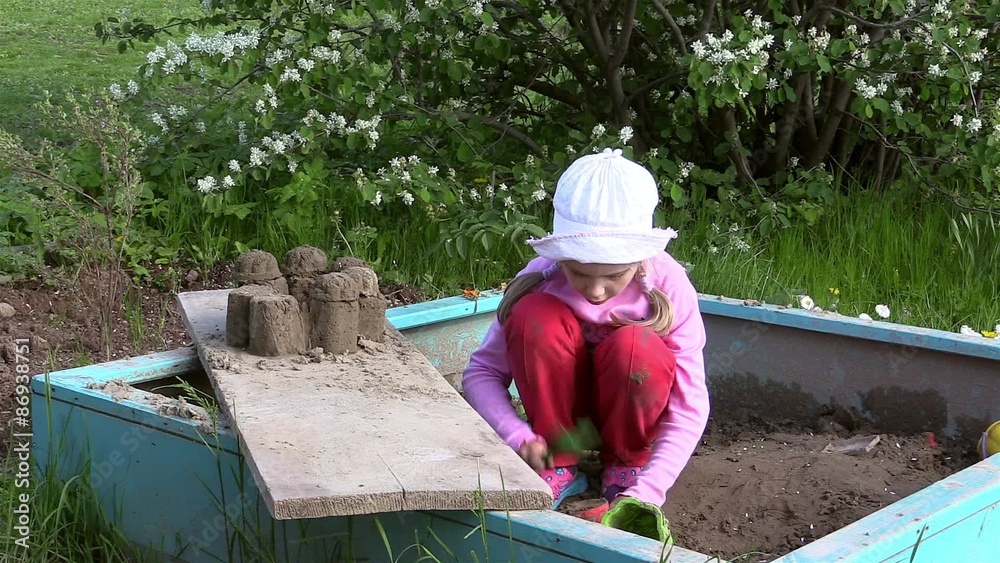 Girl playing in the sandbox Girl playing in the sandbox