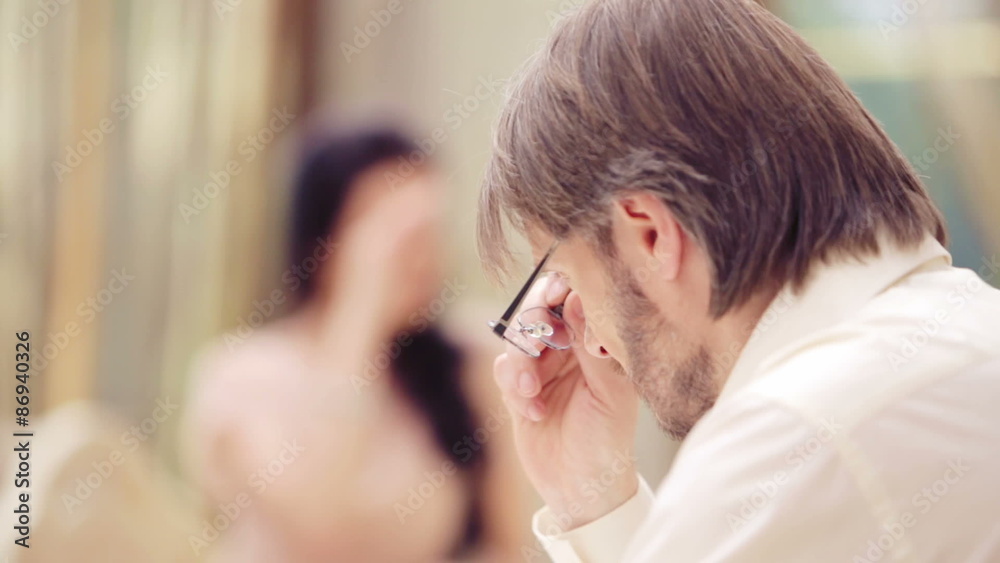 Man takes off his glasses looking at the woman. Man takes off his glasses looking at the woman.