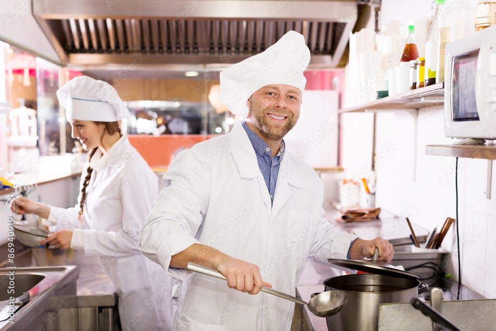 cooks cooking at professional kitchen