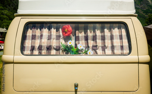 vintage curtain on an old van's window with flower