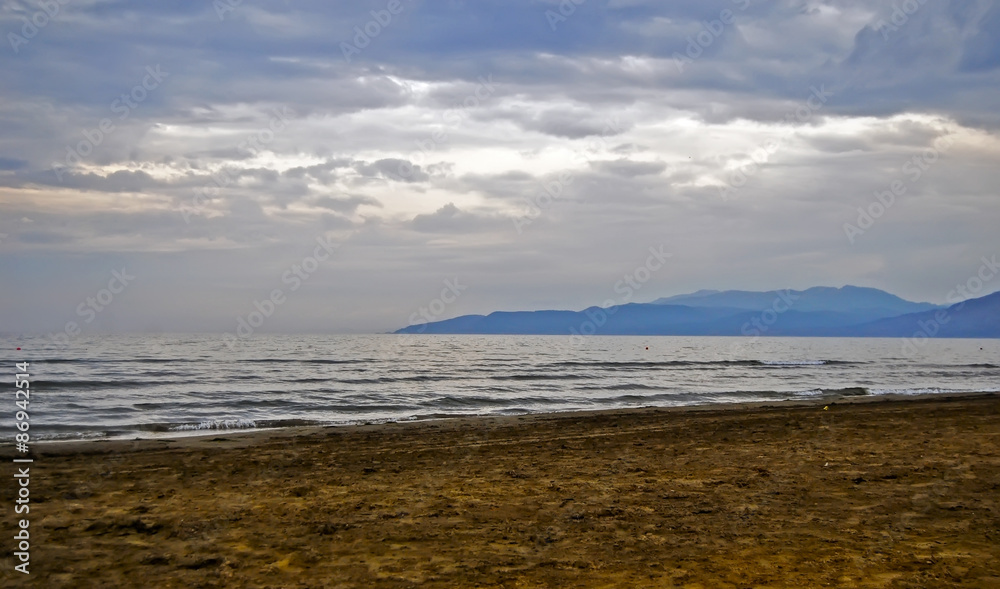 Beach, seaside with sand, water, near mountains