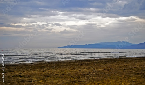 Beach  seaside with sand  water  near mountains