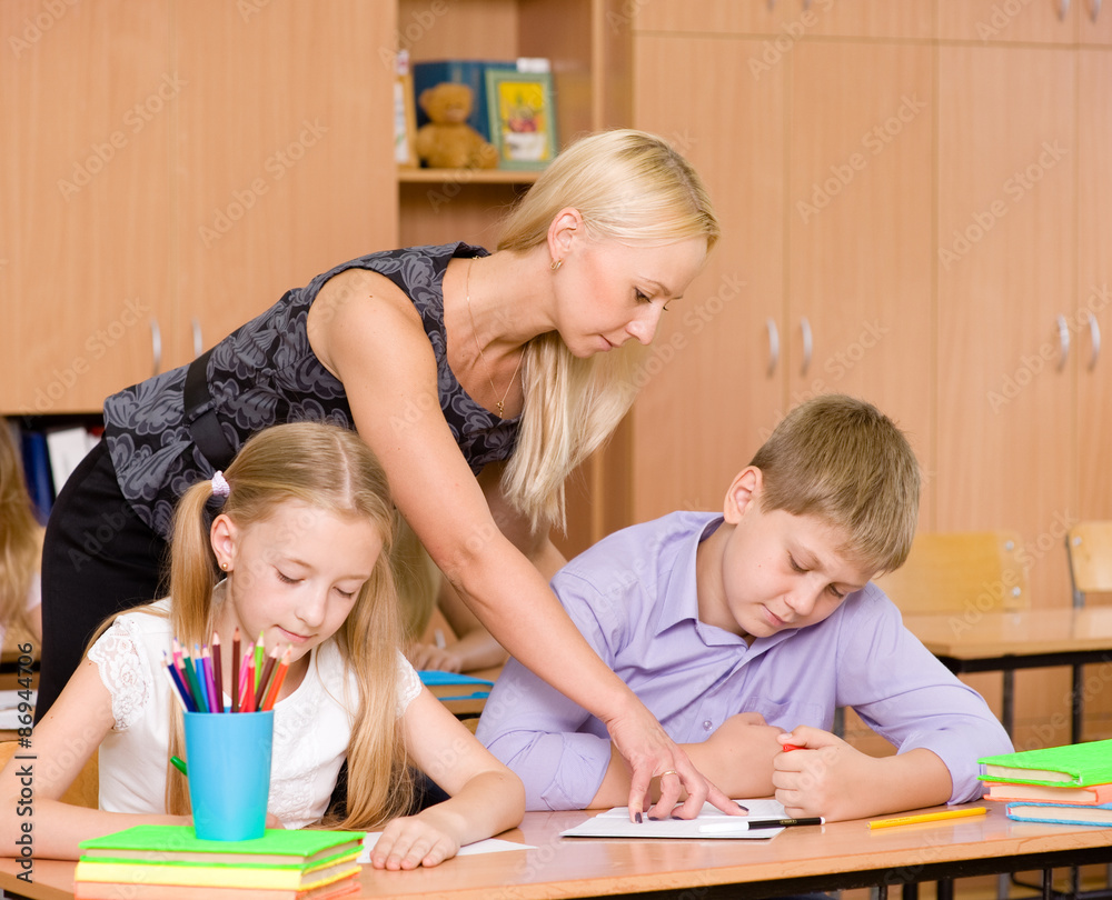 teacher helping pupil explains how to solve the task teacher helping pupil explains how to solve the task