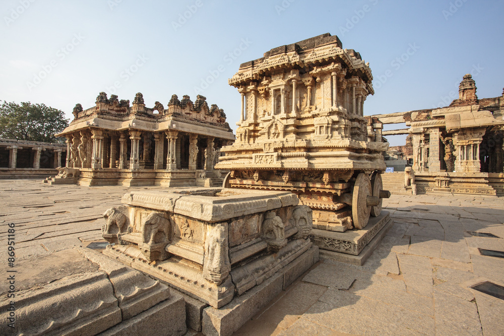 A rich carved stone chariot inside the Vittala Hindu temple in the ancient site Hampi, Karnataka, India