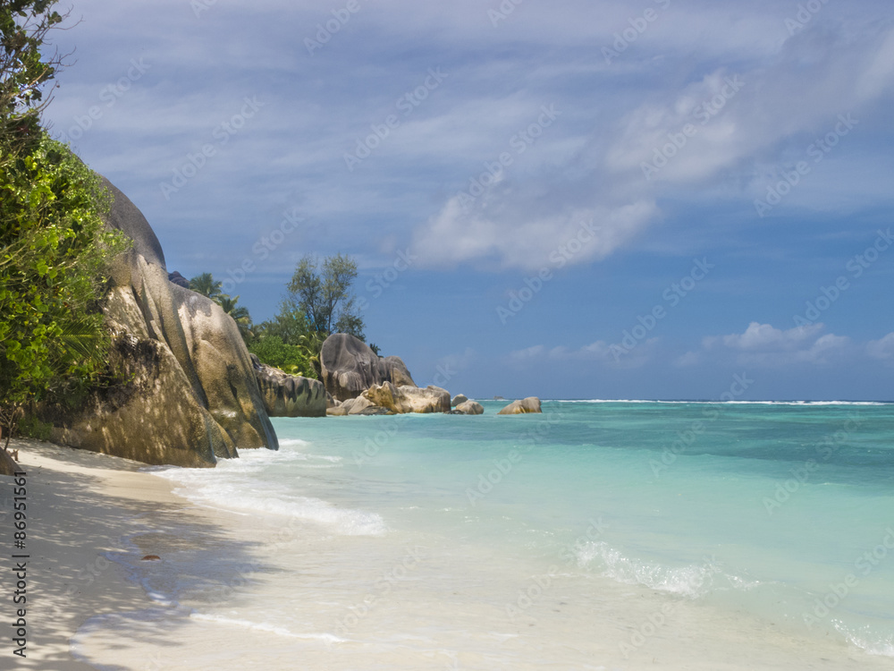 Pristine tropical beach surrounded by granite boulders