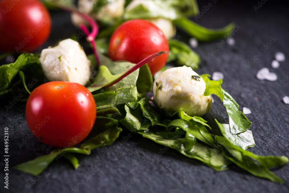 Fresh tomato and mozzarella salad on black slate