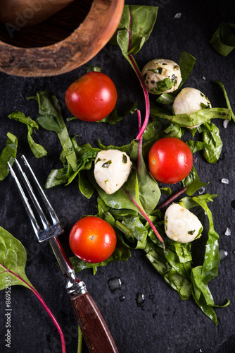 Fresh tomato and mozzarella salad on black slate