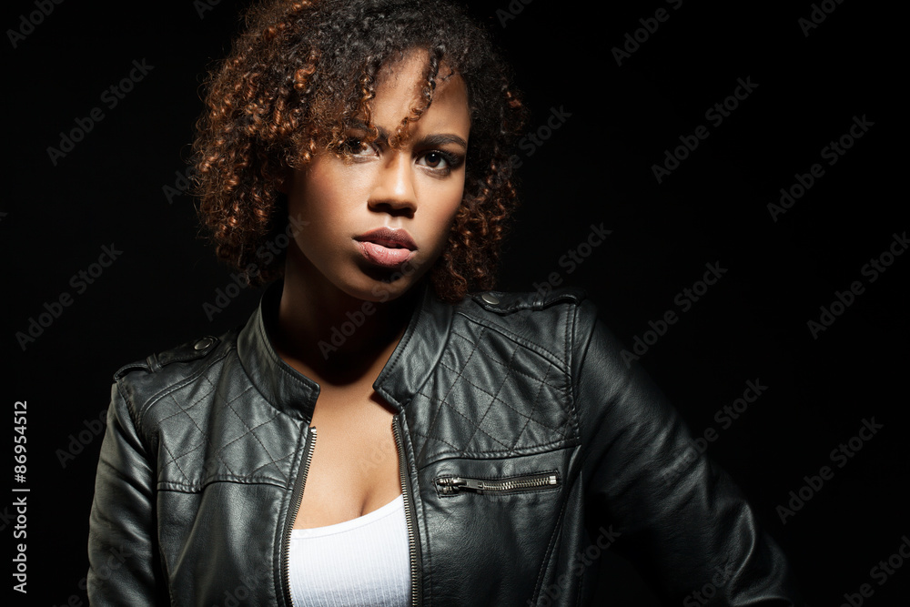 Fashion portrait of African young woman in a leather jacket with short hair Fashion portrait of African young woman in a leather jacket with short hair