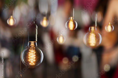 Vintage incandescent Edison type bulbs and window reflections photo