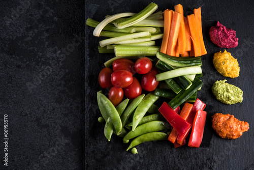 Fototapeta Naklejka Na Ścianę i Meble -  Fresh organic vegetables and vibrant dip selection