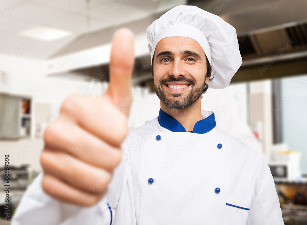 Portrait of a smiling chef in his kitchen Portrait of a smiling chef in his kitchen