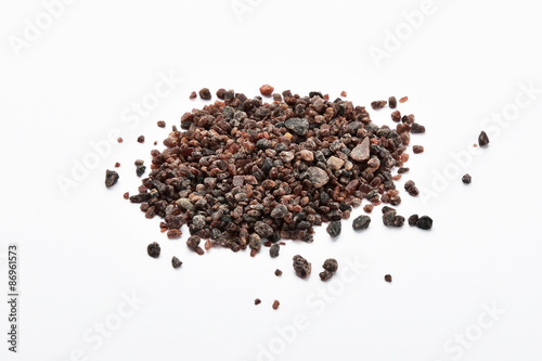 Handful of Indian brown salt isolated on white