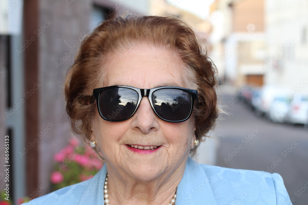 Funny grandma's portrait wearing eyeglasses with a lot of swag 