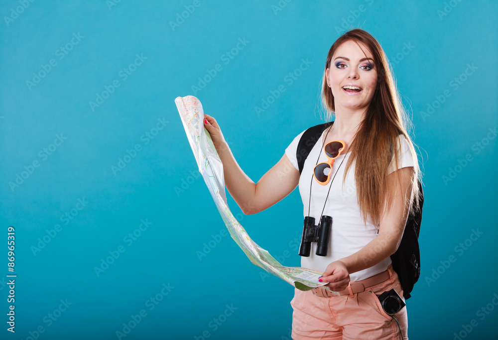 Tourist woman sunglasses read map on blue Tourist woman sunglasses read map on blue