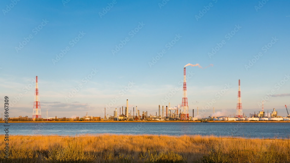 Timelapse sequence of a large oil refinery in the harbor of Antwerp, Belgium with blue sky and warm evening light. Timelapse sequence of a large oil refinery in the harbor of Antwerp, Belgium with blue sky and warm evening light.