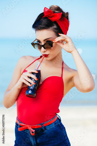 Pin-up at sea drink and watch over sunglasses Stock Photo | Adobe Stock