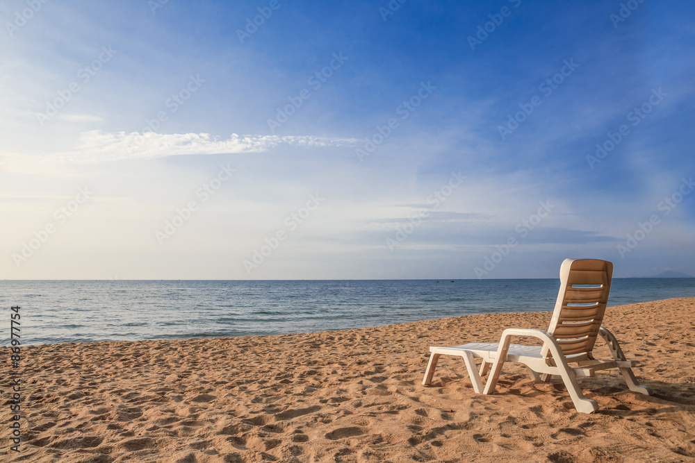 white chair on sand beach with sunshine light white chair on sand beach with sunshine light