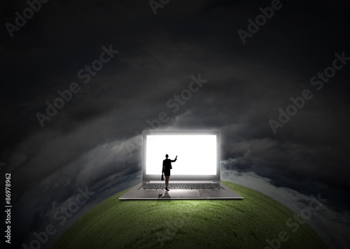 Woman standing on big laptop