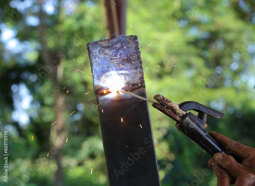 hand of worker welding metal