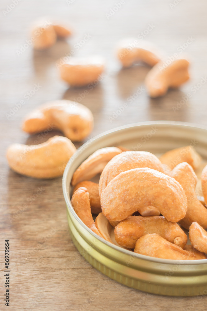 Cashew nut roast salt on weathered wooden table Cashew nut roast salt on weathered wooden table