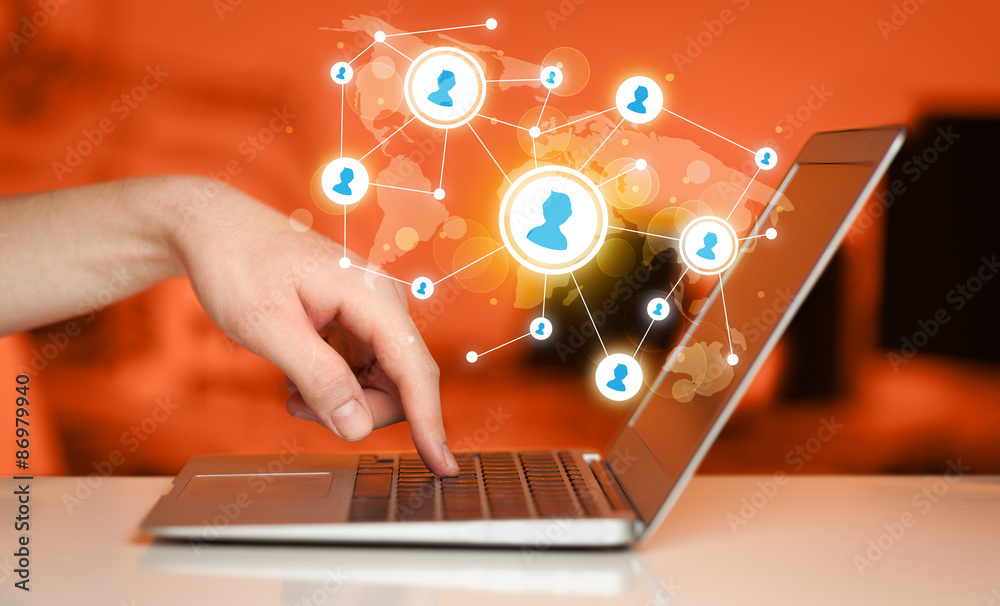Close up of hand with laptop and social media icons Close up of hand with laptop and social media icons