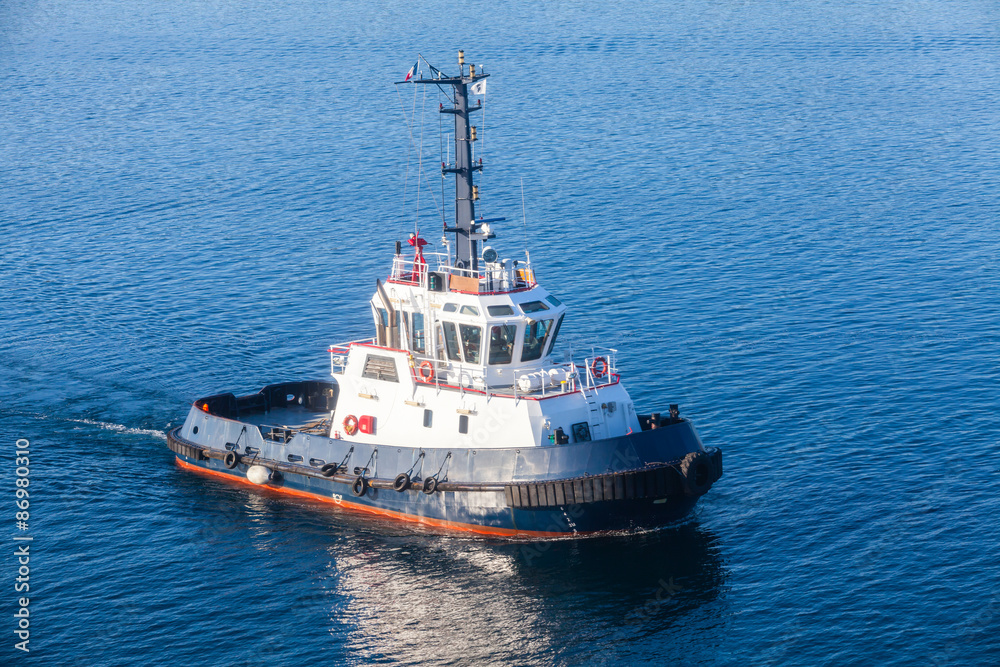 Tug boat underway on sea water