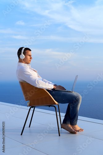 Wallpaper Mural relaxed young man at home on balcony Torontodigital.ca