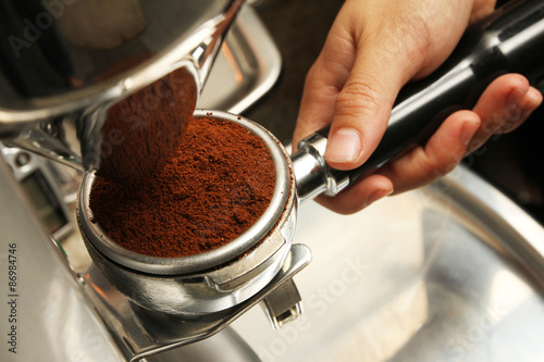 Freshly grinded coffee emptied onto coffee holder