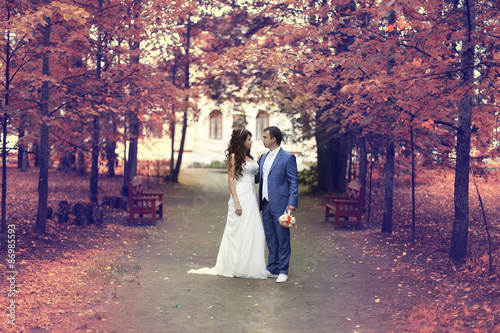 autumn wedding in the park bride and groom in a white dress